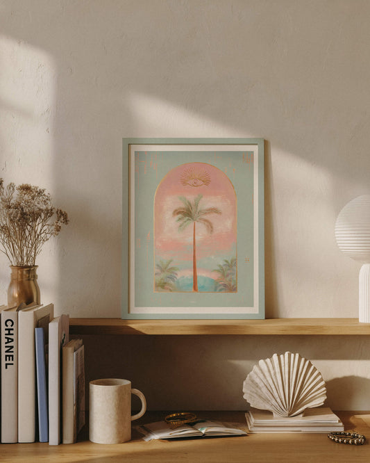 Boho chic shelf decor featuring a framed mystic palm tree print, decorative seashell, and coffee mug in a sun-drenched room.