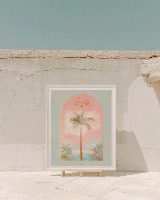 Framed artwork with a tropical design on a stone wall.