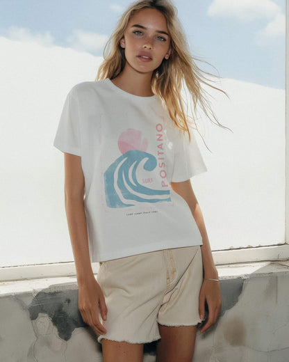 Woman wearing a white t-shirt with a graphic design outdoors